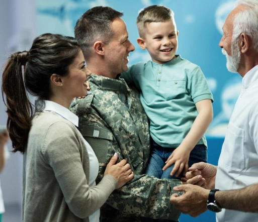 a military service member holding a young child