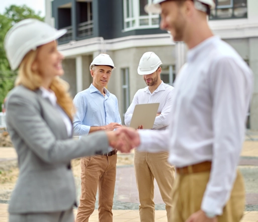 group of four people standing in a construction site