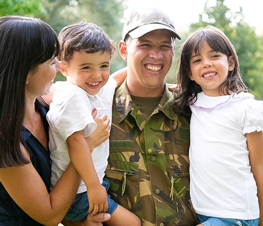 a happy military service member reuniting with their family outdoors.